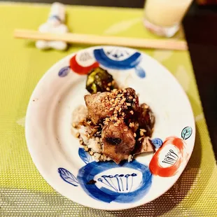 Soy-wine glazed Chilean sea bass with roasted collard greens and fried garlic