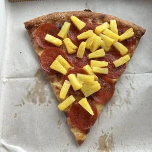 Slice of pepperoni &amp; pineapple pizza