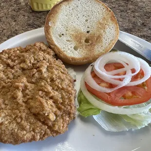 a burger and a knife on a plate