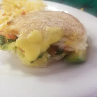 Avacado egg white sandwich with hash browns .