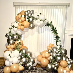 Bridal balloon arch with flowers and greenery