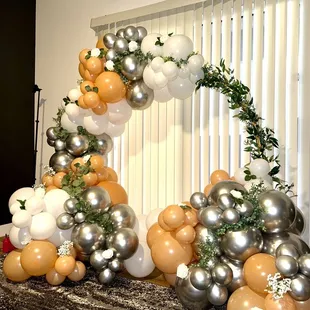Bridal balloon arch with flowers and greenery