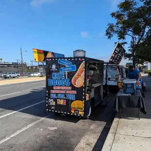  hot dog truck parked on the side of the road