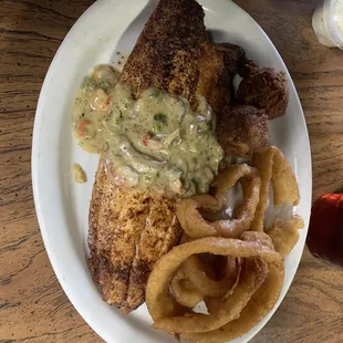 Red Fish with crawfish sauce and onion rings.