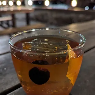 a drink in a glass on a wooden table
