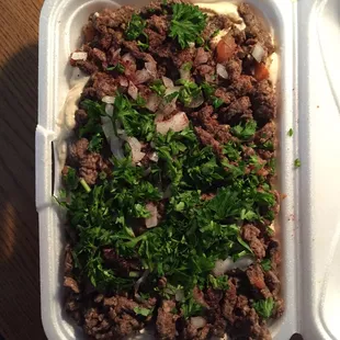 Shawarma Plate over Hommus. With onion and parsley.