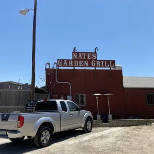 a pickup truck parked in front of a restaurant