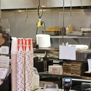 Un-refrigerated food over grill, hashbrowns, bacon, and sausage.