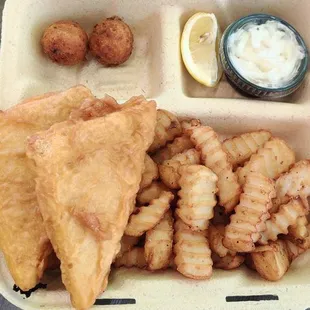 ish and chips in a styrofoam container