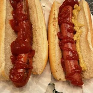 two hot dogs with ketchup and mustard