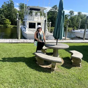 a woman sitting at a picnic table