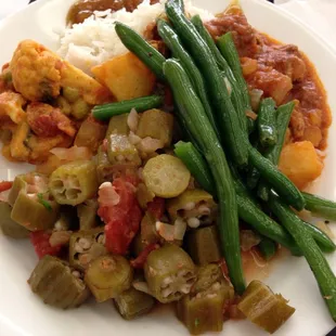 Indian lunch. Peas and potato curry, Pork Vindaroo, Sautéed okra and tomatoes.