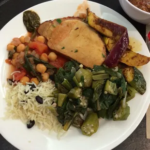 Jamaican pork lunch with veggies and rice.