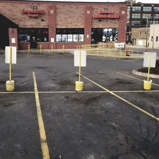 empty parking lot with yellow poles