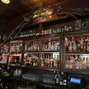 a bar with many bottles of alcohol