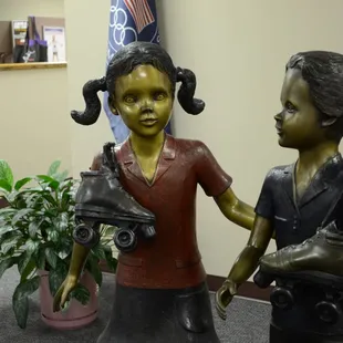 Statues of children in the office area