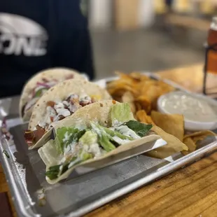 a tray of tacos and chips