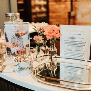 a bar with a menu and flowers