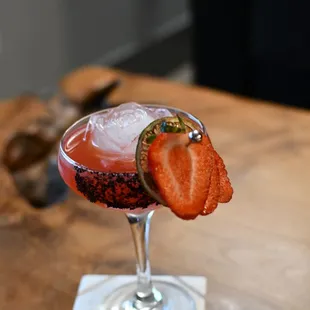 a strawberry cocktail with a garnish garnish
