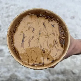 a person holding a bowl of ice cream