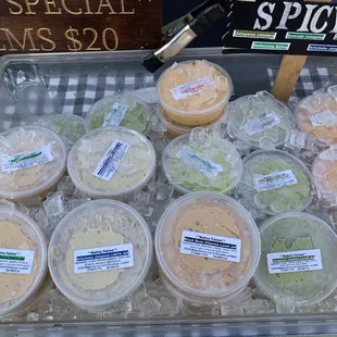 a variety of dips in plastic containers