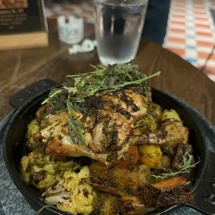 chicken and vegetables in a cast iron skillet