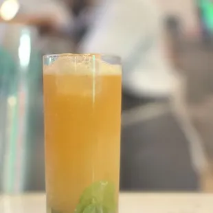 a glass of orange juice on a table