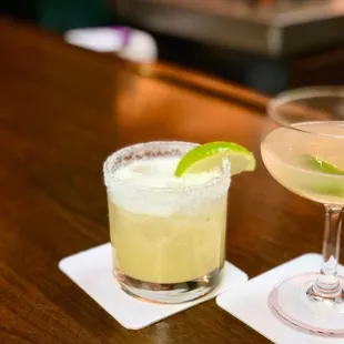 two cocktails on a bar