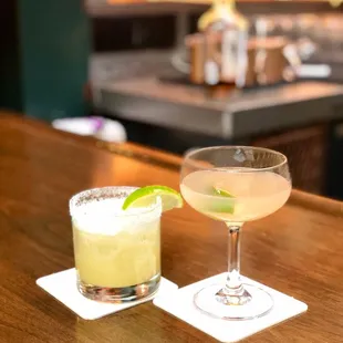 two cocktails on a bar