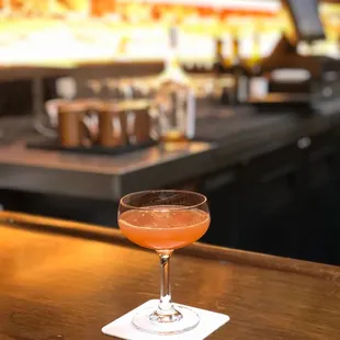 a glass of wine on a bar