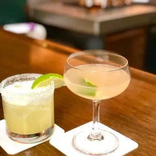 two cocktails on a bar