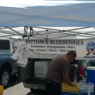 a man preparing food under a tent