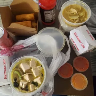Green curry, yellow curry, white rice, and spring rolls.