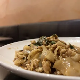 a plate of noodles and meat