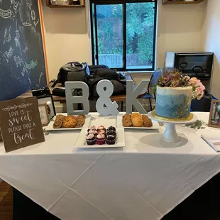 a table with a cake and pastries