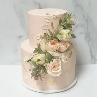 Two tier buttercream cake, palette knife design with cascading flowers!
