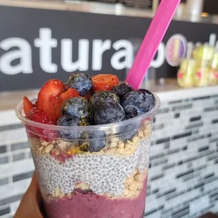 a hand holding a smoothie