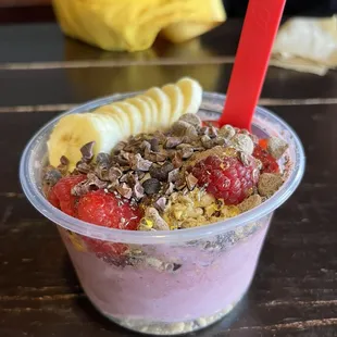 a yogurt filled with fruit and granola