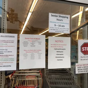 a grocery store window with signs