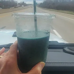 a hand holding a drink