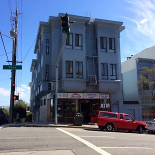 a red car parked in front of a blue building