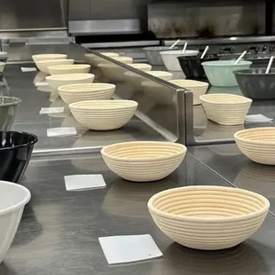a kitchen counter with bowls and utensils