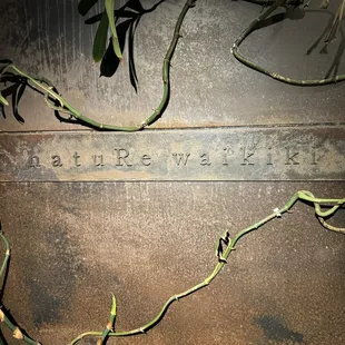 Restaurant signage behind an iron gate which is opened at 5:30pm when the restaurant is open for customers