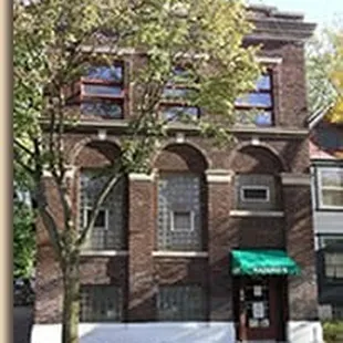 a brick building with a green awning