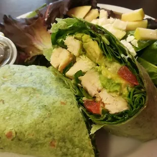 Grilled chicken wrap yummy with lots of avocado and a side salad of spring greens, feta and
