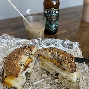a sandwich cut in half on aluminum foil