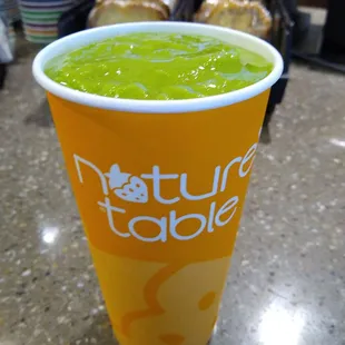 Spinach, kale,  pineapple, and  mango smoothie