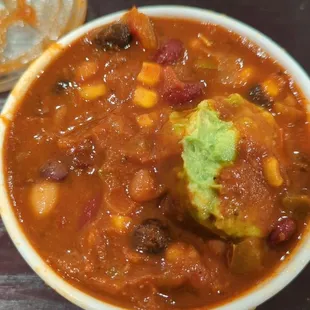 a bowl of chili and guacamole