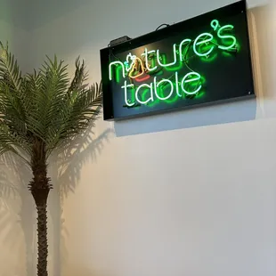 a palm tree and a neon sign