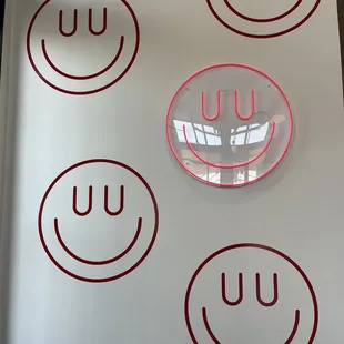 a number of smiley faces on a wall